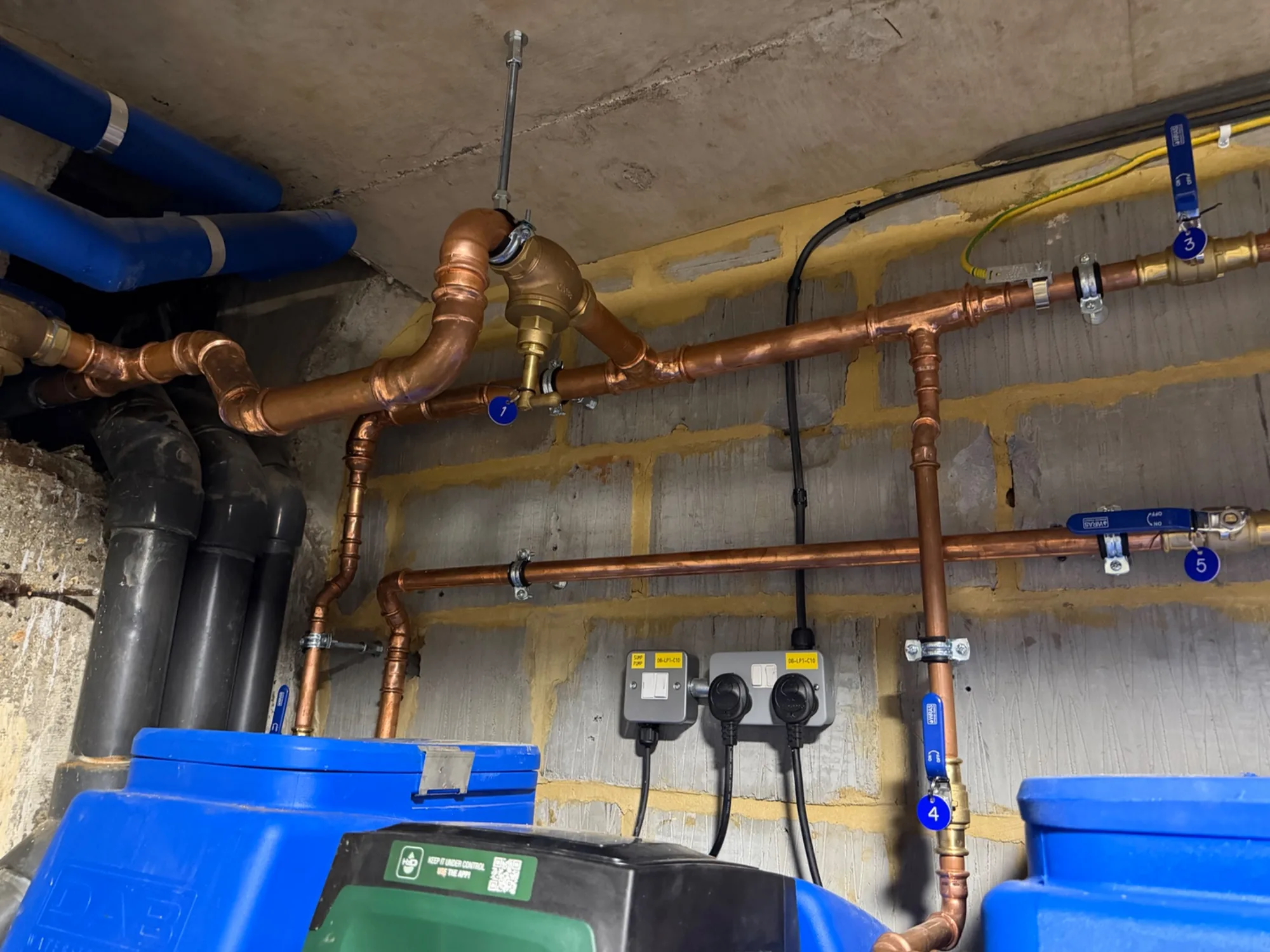 Copper heating pipework, circulation pumps and water treatment in a plant room