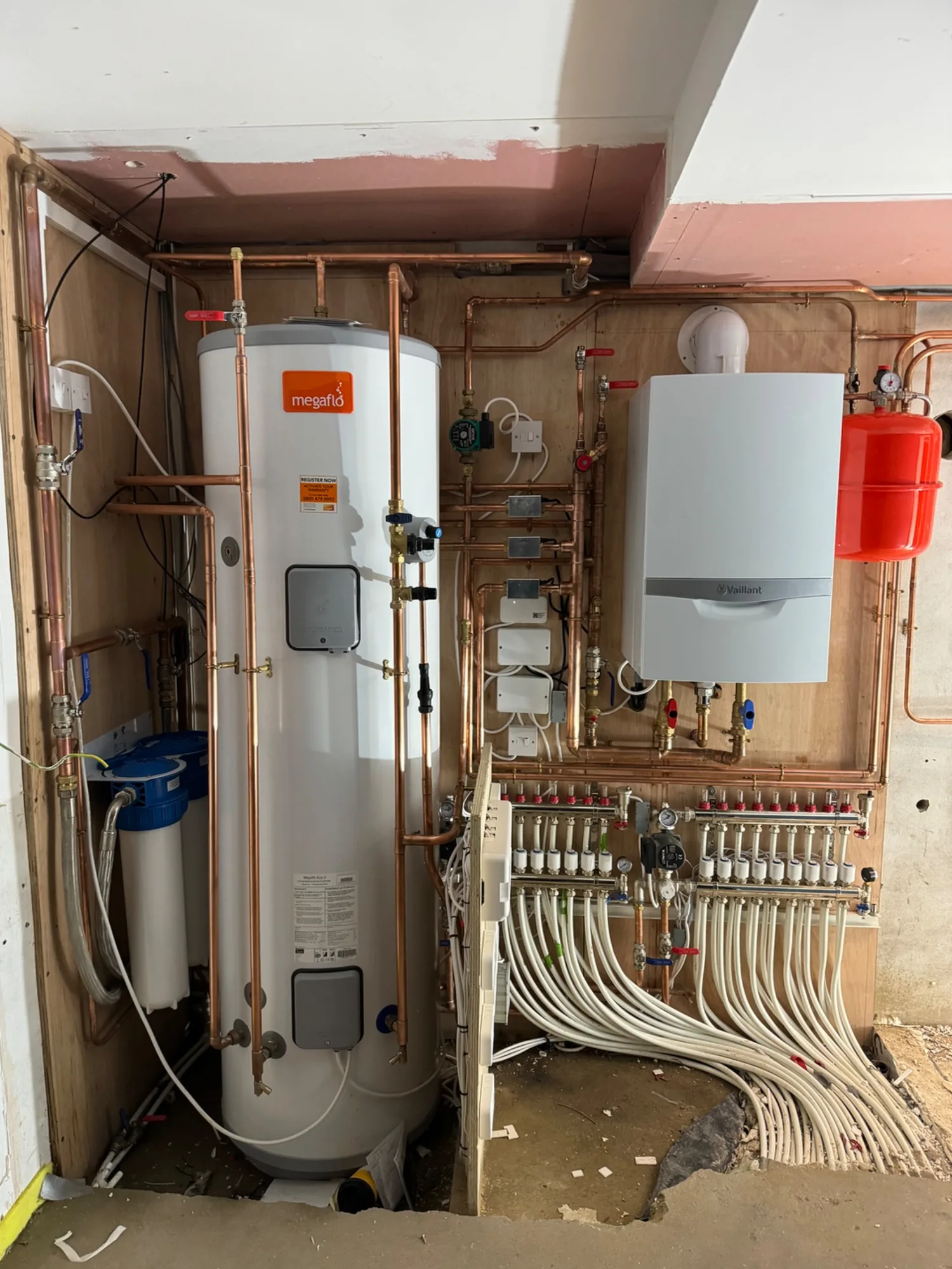 Megaflo unvented cylinder alongside a Vaillant boiler and underfloor-heating manifold